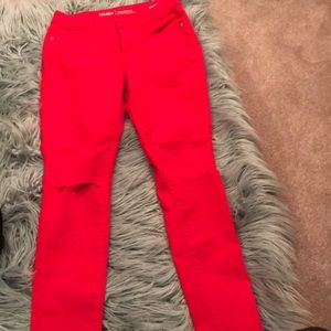 red mid-rise ripped rockstar jeans